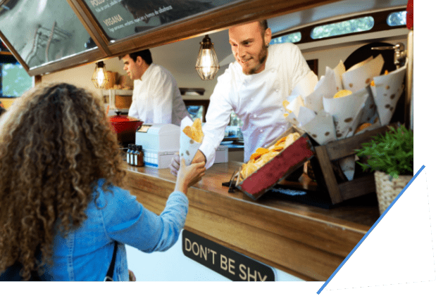 Customer receiving food from chef inside food truck