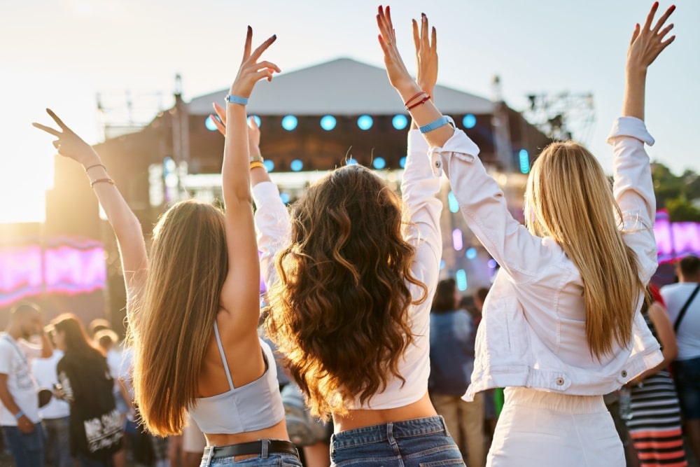 three young women at a music festival