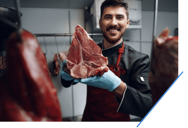 Butcher holding up a piece of meat